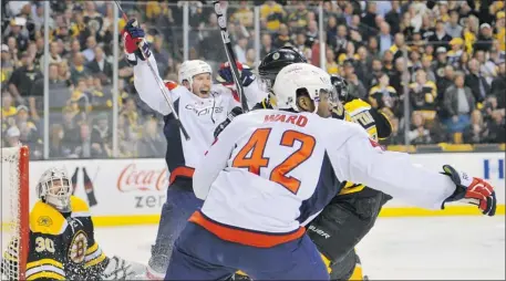  ?? Brian Babineau, Getty Images ?? Washington’s Mike Knuble, left, and Joel Ward celebrate a win in overtime against the Boston Bruins in Game 7 on Wednesday night.