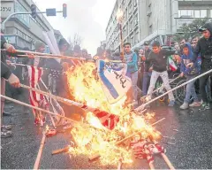  ?? REUTERS ?? Iranians burn US flags during a ceremony to mark the 40th anniversar­y of the Islamic Revolution in Tehran yesterday.