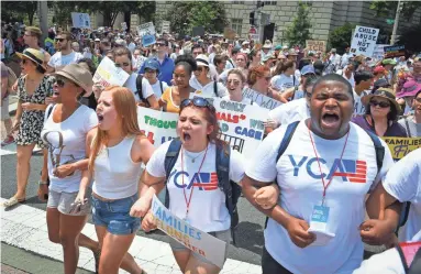  ?? JACK GRUBER/USA TODAY ?? Protesters march during the Families Belong Together rally Saturday in Washington.