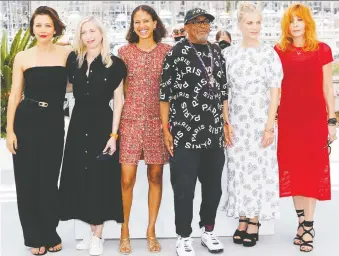  ?? JOHANNA GERON/REUTERS ?? Director Spike Lee, jury president of the 74th Cannes Film Festival, poses with its female jurors, including Maggie Gyllenhaal, left, Jessica Hausner, Mati Diop, Mélanie Laurent and Mylène Farmer.