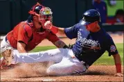  ?? JOHN BAZEMORE/ASSOCIATED PRESS ?? Braves third baseman Jake Lamb slides past Red Sox catcher Christian Vazquez to score on a Cristian Pache sacrifice fly in the fifth inning Tuesday at Cooltoday Park in North Port, Fla.