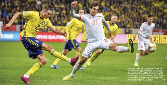  ?? — AP ?? Sweden’s Mikael Lustig (left) vies for the ball with Spain’s Mikel Oyarzabal during their Euro 2020 Group F qualificat­ion match at Friends Arena in Solna, Stockholm, Sweden, on Tuesday. The match ended in a 1-1 draw.