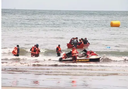  ??  ?? Emergency: Rescuers setting out on watercraft searching for the missing triathlete in Port Dickson.