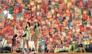  ?? AFP ?? MOUNT ARLINGTON, US:
THE HAGUE: People walk under festive decoration­s for the upcoming Lunar New Year outside a shopping mall in Bangkok, Thailand.