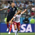  ?? DU YU/TRIBUNE NEWS SERVICE ?? Dejan Lovren, left, of Croatia vies with Andreas Cornelius of Denmark during their 2018 FIFA World Cup Round of 16 match on July 1.