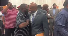  ?? JENNIFER PIGNOLET ?? Former football coach Teli White, on right, greets supporters after the hearing on his terminatio­n in front of the school board June 6.