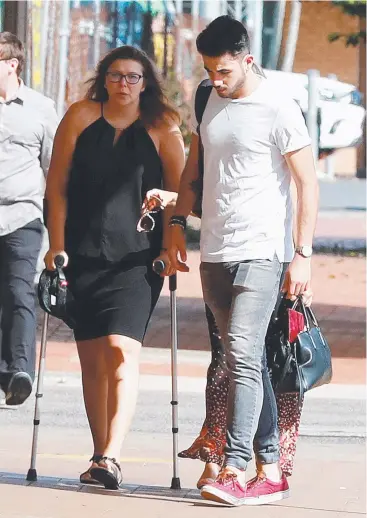  ?? Picture: JUSTIN BRIERTY ?? DELAY: French woman Cindy Gonin, aided by crutches and supported by family and friends, enters the Cairns District Court for sentencing on Tuesday.