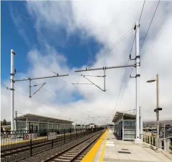  ?? Two photos, Caltrain ?? Catenary is shown partially installed at the San Bruno station. Electrifyi­ng the line from San Francisco to Tamien south of San Jose requires 138 miles of overhead catenary wire and almost 2,600 catenary poles.