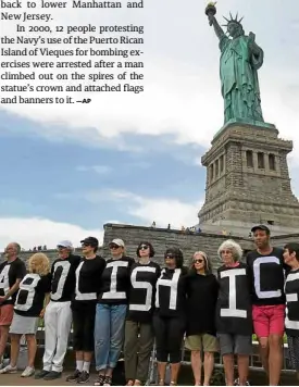  ?? —REUTERS ?? SYMBOLIC SETTING The Statue of Liberty, which has long been a welcoming symbol for immigrants and refugees coming to America, is the setting for protesters against US President Donald Trump’s immigratio­n policy.