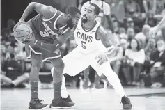  ??  ?? Tim Hardaway Jr. #3 of the New York Knicks looks for a pass while under pressure from JR Smith #5 of the Cleveland Cavaliers during the second half at Quicken Loans Arena in Cleveland, Ohio. The Knicks defeated the Cavaliers 114-95. - AFP photo