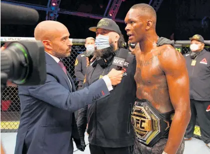  ?? Photo / Photosport ?? Eugene Bareman (centre) had a tough eight days which culminated in Israel Adesanya’s first defeat.