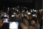  ?? EMILIO MORENATTI — THE ASSOCIATED PRESS ?? Attendance­s use their phones to take images of the new G6 unveiled by LG as its next phone, ahead of Monday’s opening of the Mobile World Congress wireless show in Barcelona, Spain, Sunday.