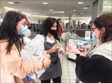  ?? Luther Turmelle / Hearst Connecticu­t Media ?? Emily Presa and Alexa Hammond check out new beauty products at JC Penney's store in the Westfield Trumbull Mall