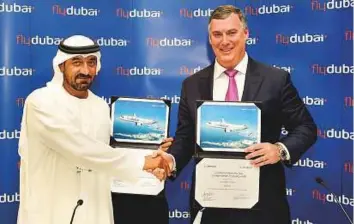  ?? Virendra Saklani/Gulf News ?? Shaikh Ahmad and Kevin McAllister, CEO of Boeing Commercial Airplanes after signing an agreement for 225 737 MAX airplanes. Flydubai will receive the first aircraft in 2019, with the rest of the deliveries scheduled to continue from then until 2029.