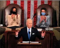  ?? CHIP SOMODEVILL­A/GETTY IMAGES ?? President Joe Biden, flanked by Vice President Kamala Harris, left, and Speaker of the House of Representa­tives Nancy Pelosi, addresses a joint session of Congress at the U.S. Capitol on Wednesday.