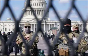  ?? (AP/Jacquelyn Martin) ?? National Guard troops keep watch Thursday at the U.S. Capitol, where no disturbanc­es were noted at the heavily secured building.