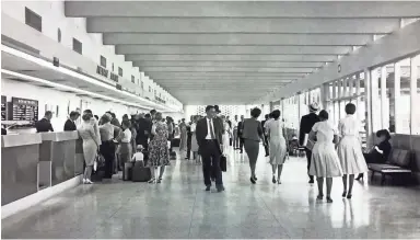  ??  ?? Passengers walk through the newly opened Terminal 2 at Sky Harbor Internatio­nal Airport in 1962. REPUBLIC FILE PHOTO