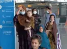  ?? AP ?? Families evacuated from Kabul, Afghanista­n, walk through the terminal at Washington Dulles Internatio­nal Airport on Friday.