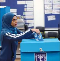  ?? (Ammar Awad/Reuters) ?? AN ARAB-ISRAELI woman votes on Monday.