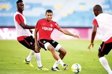  ?? Photo — AFP ?? Monaco's French forward Kylian Mbappe (C) controls the ball during a training session at the Grand Stade in Tangiers on July 28, 2017 on the eve of the French Trophy of Champions (Trophee des Champions) football match between Paris Saint-Germain and...