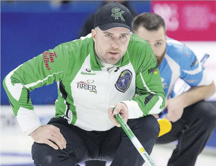  ?? ANDREW VAUGHAN/THE CANADIAN PRESS ?? Saskatchew­an skip Steve Laycock, left, and Quebec second William Dion watch a rock in their Brier match on Saturday in Regina. Quebec won 5-2.