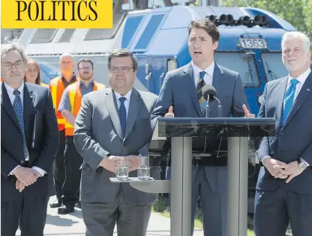  ?? PAUL CHIASSON / THE CANADIAN PRESS ?? Prime Minister Justin Trudeau announces a $1.28-billion federal government commitment toward a major Montreal rail project on June 15, flanked by Caisse de dépôt president Michael Sabia, Montreal mayor Denis Coderre and Quebec Premier Philippe Couillard.