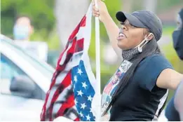  ?? STEPHEN M DOWELL/ORLANDO SENTINEL ?? Protesters block the intersecti­on of Sand Lake Road and South Orange Blossom Trail near the Florida Mall on Aug. 14, 2020. The protest was for a fatal police shooting by the Orange County Sheriff’s Department.