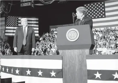  ?? CAROLYN KASTER/AP ?? President Donald Trump listens Fox News’ Sean Hannity speak at a rally in November 2018 in Cape Girardeau, Missouri.