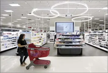  ?? AP file photo ?? A shopper walks through the updated cosmetic department at a Target store in San Antonio on May 30. “There’s no doubt that, like others, we’re currently benefiting from a very strong consumer environmen­t, perhaps the strongest I’ve seen in my career,” Target CEO Brian Cornell told investors. Target saw sales at establishe­d stores post the strongest growth in 13 years.