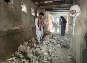  ?? SIDIQULLAH KHAN / AP ?? People inspect the inside of a mosque following a suicide bomber attack in the city of Kandahar, southwest Afghanista­n Friday.