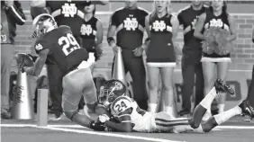  ?? Associated Press ?? Notre Dame wide receiver Kevin Stepherson (29), defended by Southern California cornerback Isaiah Langley (24) catches a 23-yard pass for a touchdown during the first half of an NCAA college football game Saturday in South Bend, Ind.