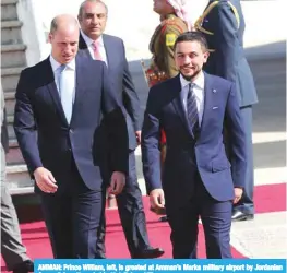  ?? —AFP ?? AMMAN: Prince William, left, is greeted at Amman’s Marka military airport by Jordanian Crown Prince Hussein bin Abdullah.