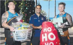  ?? Picture: STEWART McLEAN ?? Aaron Davey from AFL Cairns (centre) with Pride's Darryn Schonig and Todd Carney with some of the donations.