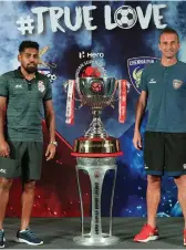  ??  ?? Captains Roy Krishna (left) of the ATK and Lucian Goian of Chennaiyin FC pose with the winner’s trophy ahead of the Hero ISL final in Goa on Saturday.