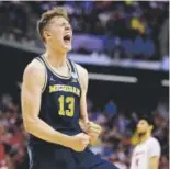  ?? Michael Conroy, The Associated Press ?? Michigan forward Moe Wagner celebrates a 73-69 win over Louisville on Sunday in a second-round game. Only one ACC team remains in the NCAA Tournament.
