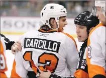  ?? Associated Press photo ?? Philadelph­ia Flyers forward Daniel Carcillo is restrained by referee Ian Walsh against the Minnesota Wild during a preseason NHL hockey game in St. Paul, Minn., in this 2010 file photo.