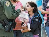  ?? JOHN MOORE/GETTY ?? A court panel said authoritie­s are bound by a 1997 settlement that guaranteed court hearings for minor migrants.