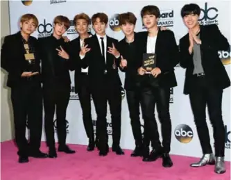  ??  ?? BTS, a South Korean band, poses in the press room with the award for Top Social Artist.