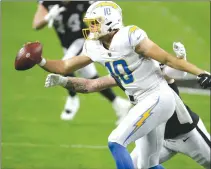  ?? Associated Press photo ?? Los Angeles Chargers quarterbac­k Justin Herbert (10) tosses the ball against the Las Vegas Raiders during the first half of an NFL football game, Thursday in Las Vegas.