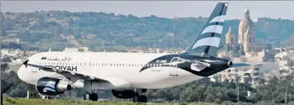  ??  ?? TENSE TIMES: A hijacked Libyan jet sits on a Malta runway Friday during a four-hour standoff that ended peacefully.