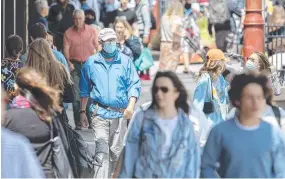  ?? ?? Pedestrian­s wearing masks in Murray St, Hobart. Picture: Chris Kidd