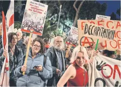  ?? AFP ?? French students and Greek workers hold placards during a rally in front of the French embassy in Athens on Thursday, against President Emmanuel Macron.