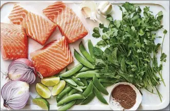  ??  ?? Seared sugar snap peas and red onions make a sweet accompanim­ent to silky salmon fillets.