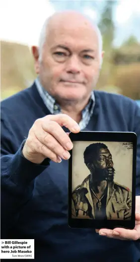  ?? Tom Wren/SWNS ?? > Bill Gillespie with a picture of hero Job Maseko