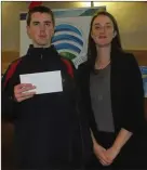 ??  ?? Tadhg Kiely receives his award from Ciara Fitzgerald of Mallow Credit Union.