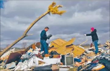  ?? Joe Raedle
Getty Images ?? IN HOLTON, IND., Mark Belanger and April Roberts see what they can salvage from the home of Belanger’s in-laws. Family members were in the house when it was destroyed; all survived but are in the hospital.