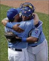  ?? CHARLIE RIEDEL — THE ASSOCIATED PRESS ?? The Royals’ Salvador Perez, right, and manager Ned Yost hug after the Royals defeated the Boston Red Sox, 6-4, on June 21 in Kansas City.