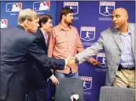  ?? Bebeto Matthews / Associated Press ?? MLB Commission­er Bud Selig, left, shakes hands with MLB Players Associatio­n Director of Player Relations Tony Clark at a news conference in 2011.