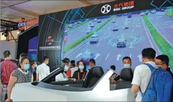  ?? PROVIDED TO CHINA DAILY ?? Visitors are drawn to a remotely-controlled vehicle developed by Beijing-based automaker BAIC Group at the ongoing China Internatio­nal Fair for Trade in Services in Beijing.