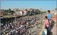  ?? AP/PRABHJOT GILL ?? A crowd gathers Saturday at the site of the train accident in Amritsar, India.